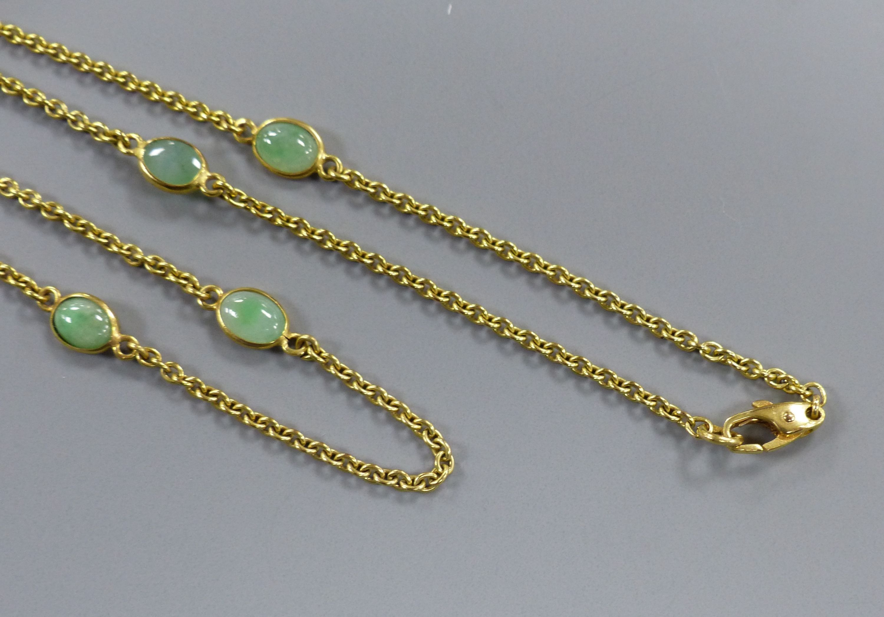 A modern 9ct gold and eight stone cabochon jade set 'spectacle' necklace, 60cm,